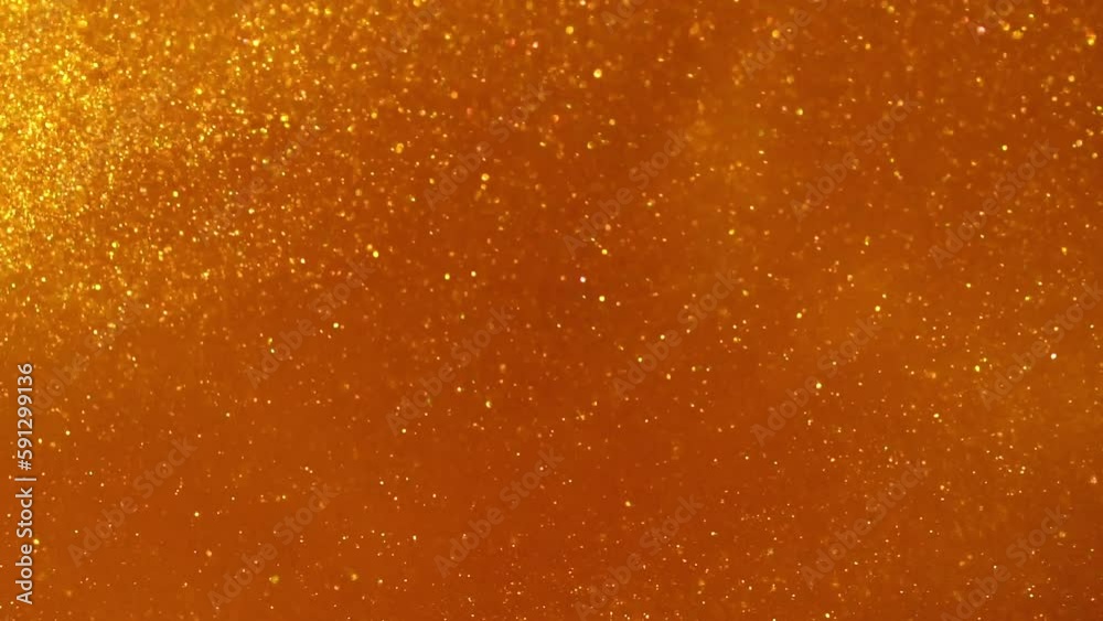 Falling Gold Glitter Dust Particles. Abstract Dispersion of shiny gold particles in fluid. Golden background of festive twinkling gold glitter. Falling Gold Glitter Dust Particles. Abstract Dispersion of shiny gold particles in fluid. Golden background of festive twinkling gold glitter.