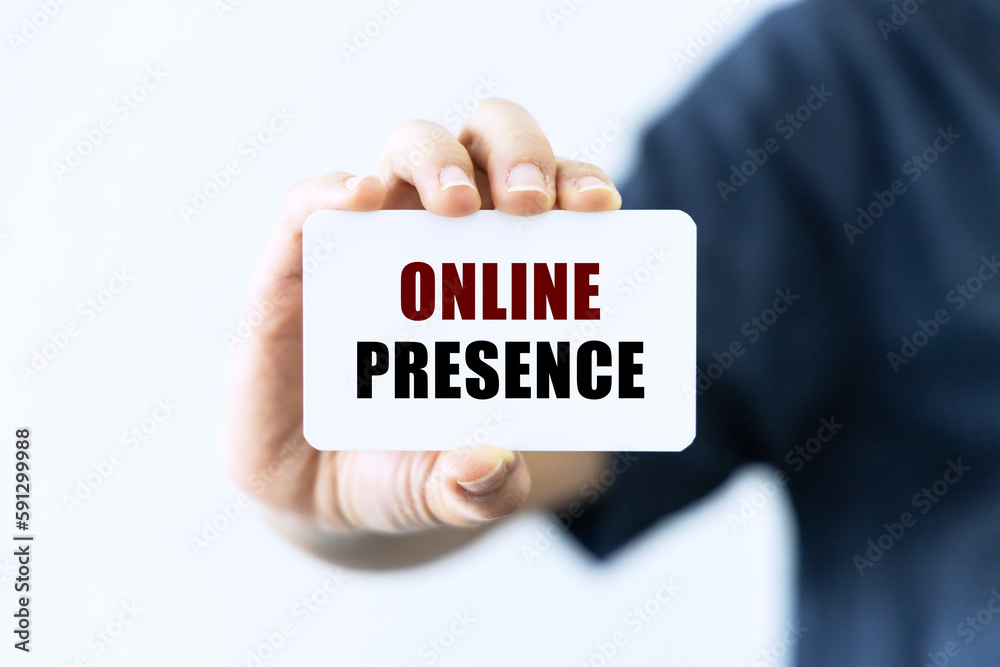 Online presence text on blank business card being held by a woman's hand with blurred background. Business concept about online presence. Online presence text on blank business card being held by a woman's hand with blurred background. Business concept about online presence.