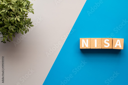 There is wood cubes with the word NISA. It is an abbreviation for Nippon Individual Savings Account as eye-catching image. photo