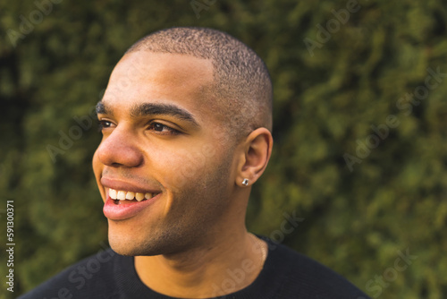 Foto Close portrait of smiling young African American man with a buzz cut isolated