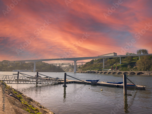 Fishing pier near the river beach of Areinho on the bank of Gaia on the Douro river at sunset. Portugal photo