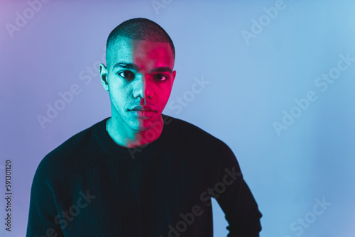 Portrait of African American man in a studio neon light. High quality photo