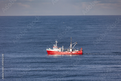 A red cutter the North sea close to Egmond aan Zee, Netherlands