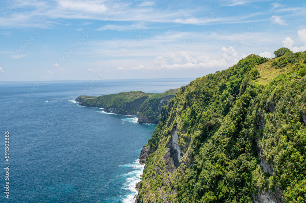 The beautiful sandy beach with rocky mountains and clear water in Nusa Penida, Bali, Indonesia