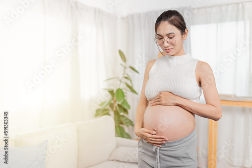 pregnant Asian people stand in white room, she use her hand touch on her abdomen, she feeling love and care her daughter, pregnancy health care promotion Free Download pregnant Asian people stand in white room, she use her hand touch on her abdomen, she feeling love and care her daughter, pregnancy health care promotion - GFXLoad