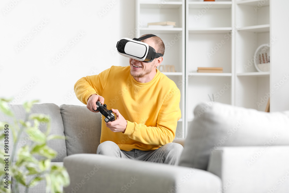 Young man with VR glasses playing video game at home Young man with VR glasses playing video game at home