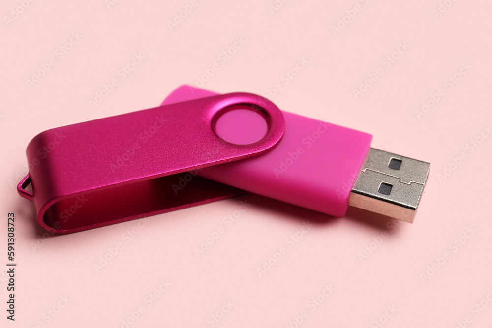 USB flash drive on pink background USB flash drive on pink background