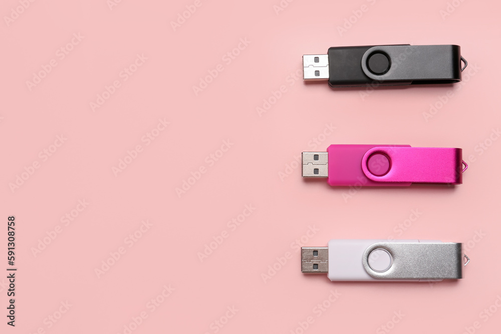Set of USB flash drives on pink background Set of USB flash drives on pink background