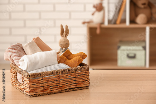 Basket with baby clothes an...