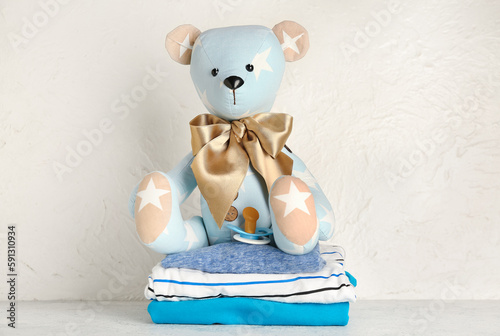 Toy bear with baby clothes ...
