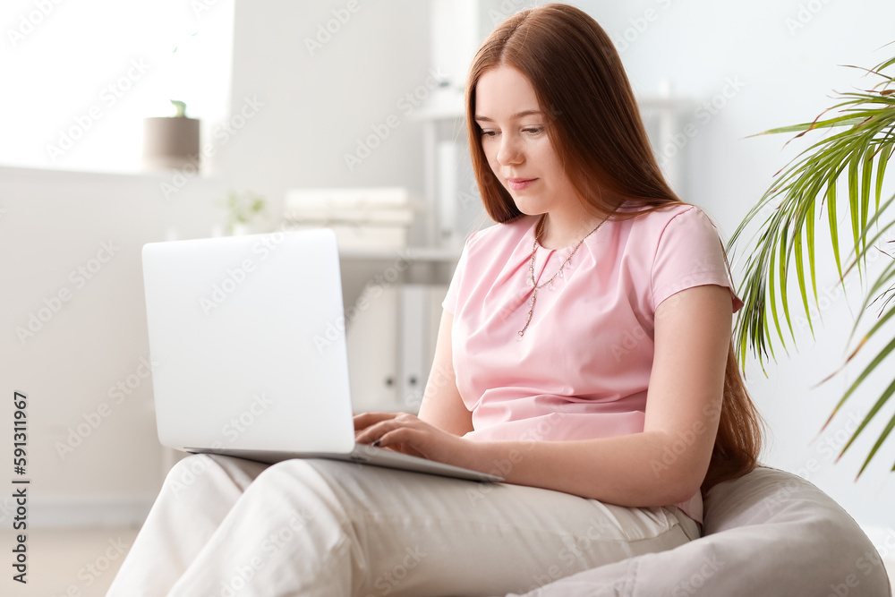 Female programmer working with laptop in office