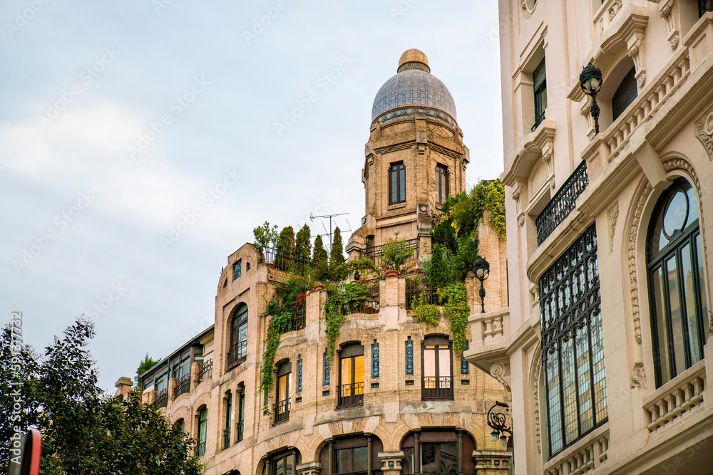 Historic old buildings in the shopping street Gran Via in Madrid before sunset