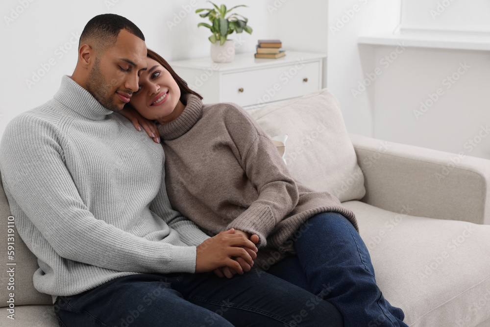 Dating agency. Happy couple spending time together on sofa at home Dating agency. Happy couple spending time together on sofa at home