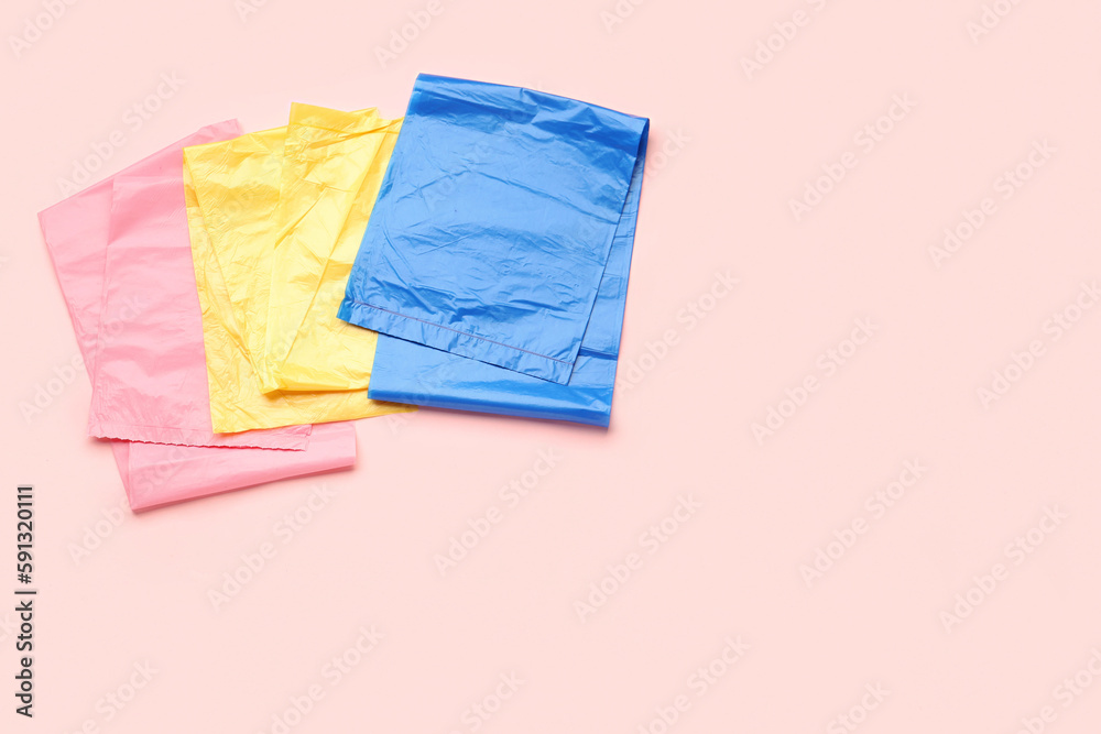 Different garbage bags on pink background Different garbage bags on pink background