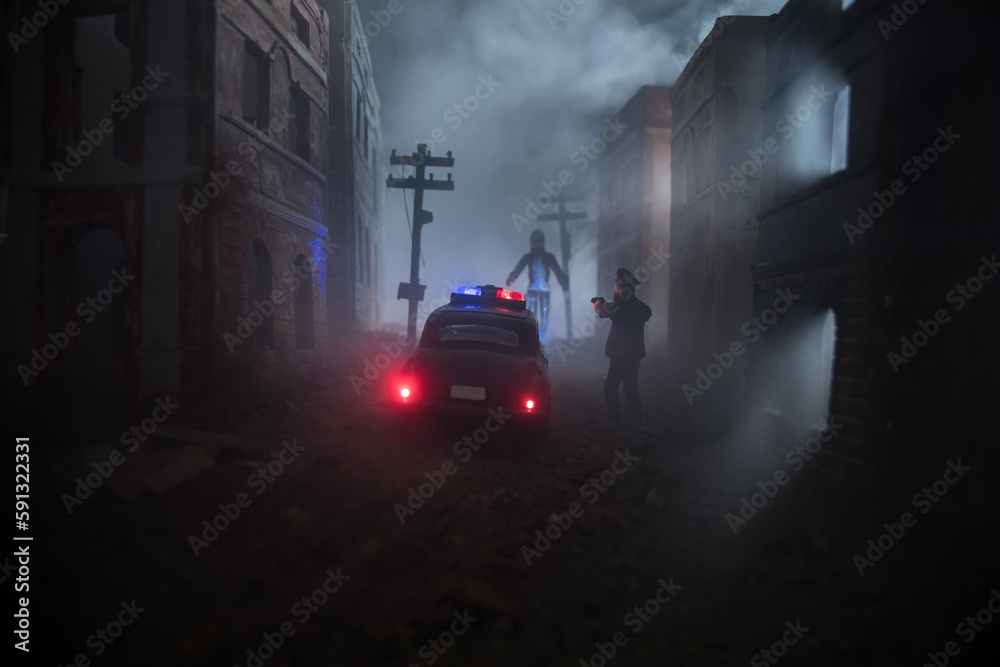 Obraz premium Police raid at night and you are under arrest concept. Silhouette of handcuffs with police car on backside. Image with the flashing red and blue police lights at foggy background. Slider shot