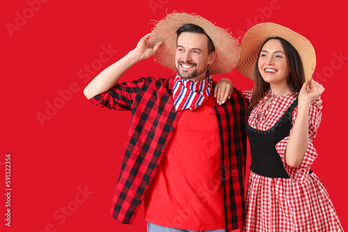 Young couple on red backgro...