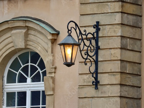 Old style street lamp on Echternach Abbey main facade. Luxembourg