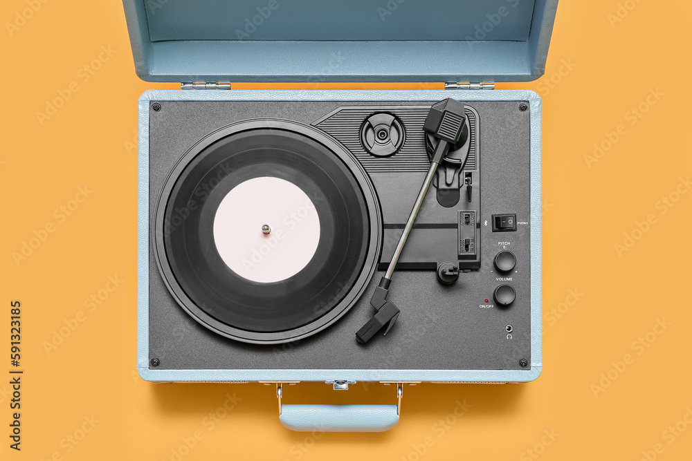 Fototapeta premium Record player with vinyl disk on yellow background