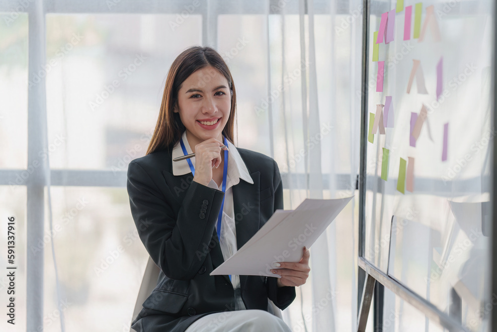 Asian Business person makes analysis and research financial report at office, analyzes profits. Accountant checks status of financial Asian Business person makes analysis and research financial report at office, analyzes profits. Accountant checks status of financial