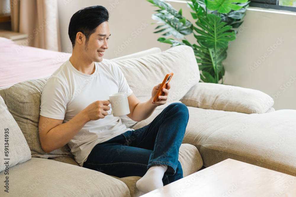 portrait of asian man sitting on sofa at home portrait of asian man sitting on sofa at home