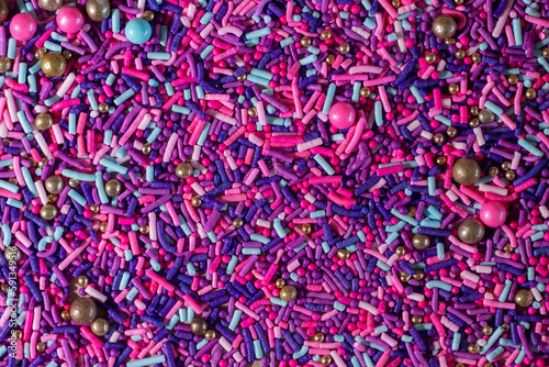 Pink, purple, and blue sprinkle texture close up