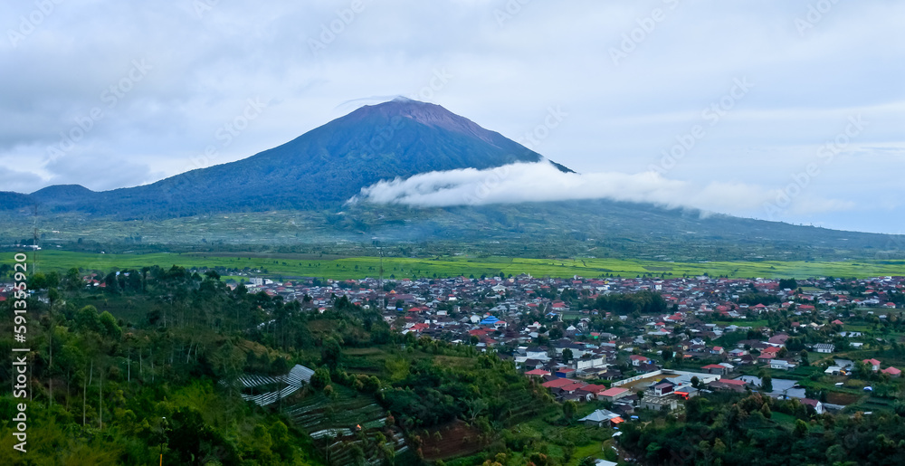beautiful view of the town of Kayu Aro at the foot of Mount Kerinci, with Mount Kerinci in the background