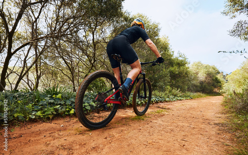 Sports  fitness and cycling with woman on dirt path in nature for workout  training and competition. Strong  cardio and exercise with female cyclist riding on mountain bike for adventure and journey