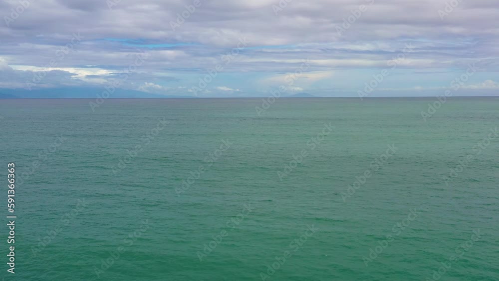 Blue ocean with waves and sky with clouds, seascape aerial drone. Blue sea water with waves against sky. Summer and travel vacation concept. Blue ocean with waves and sky with clouds, seascape aerial drone. Blue sea water with waves against sky. Summer and travel vacation concept.