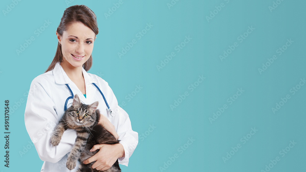 Smiling female vet holding a cute cat