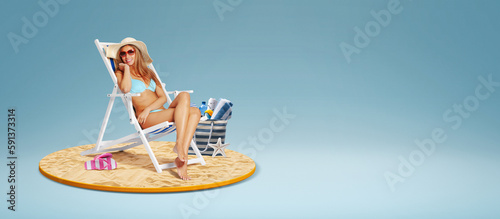 Fotografie Attractive woman sitting on a deckchair on the beach