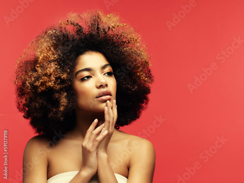 Young beautiful african american woman with afro hair. Glamour makeup.