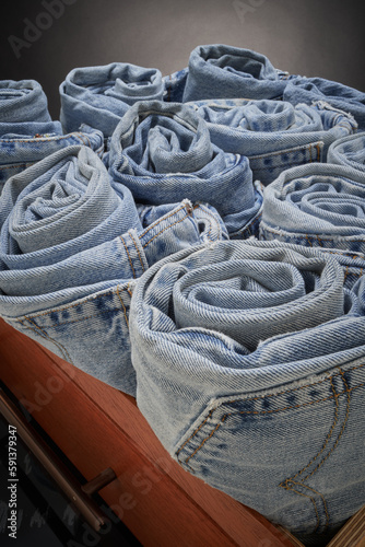 Faded blue jeans, rolled up & organized © Cavan