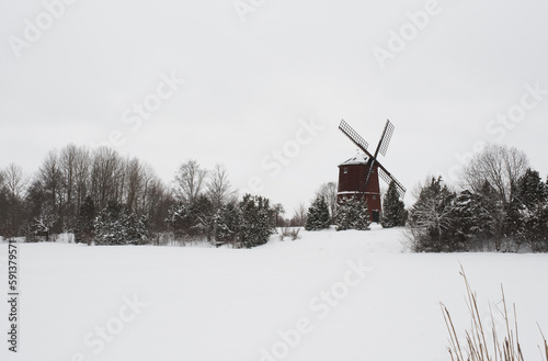Photography Swedish windmill in a field covered in snow