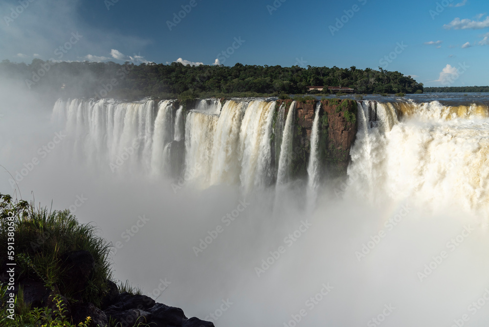 Beautiful view to Iguazu Falls waterfalls with green rainforest 