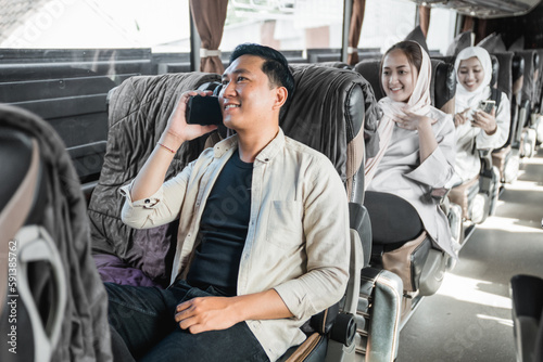 people are using smartphone while riding a bus back to their hometown