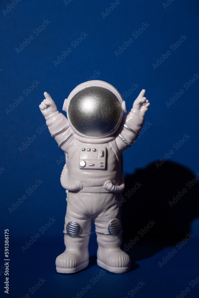 Plastic toy astronaut on colorful blue background Copy space. Concept of out of earth travel, private spaceman commercial flights. Space missions and Sustainability Plastic toy astronaut on colorful blue background Copy space. Concept of out of earth travel, private spaceman commercial flights. Space missions and Sustainability