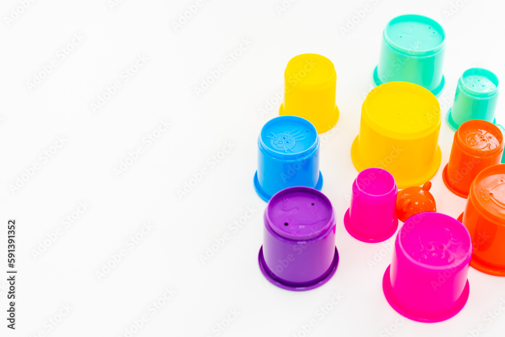 children's educational game on the table, colorful cups, sorter