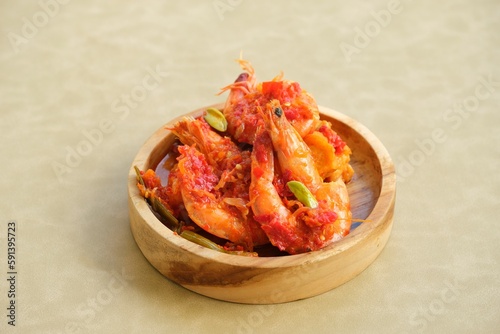 Udang goreng balado or fried shrimp with chilli paste on plate. photo