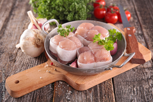 raw veal meat fillet with ingredient on wooden  board photo
