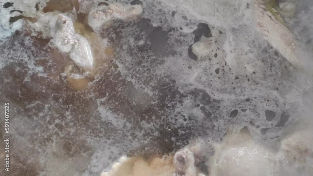 Boil the chicken in a pot of boiling water. Boil the chicken in a pot of boiling water.
