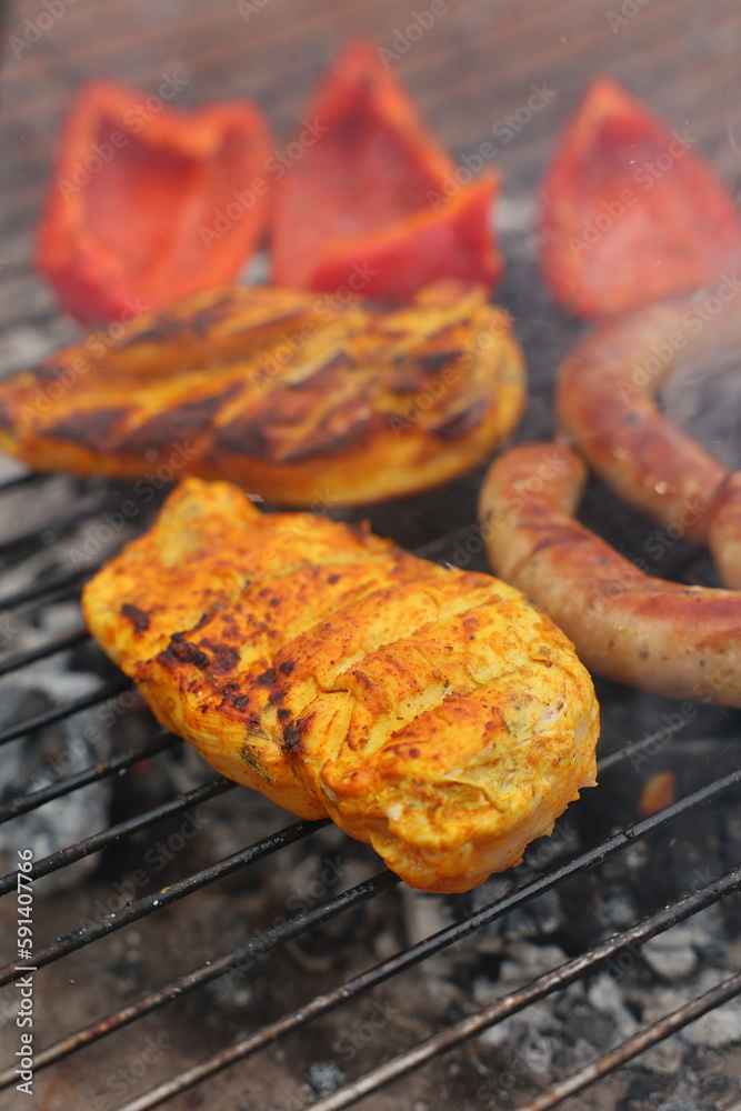 grilled vegetables, grilled chicken fillet and sausages, grilled vegetables, grilled red pepper. Roasted sausages on the campfire