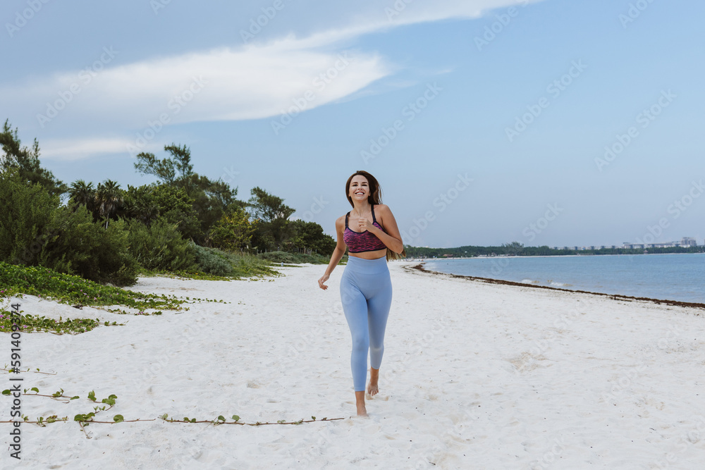 latin young woman running at beach in Mexico Latin America, hispanic people latin young woman running at beach in Mexico Latin America, hispanic people