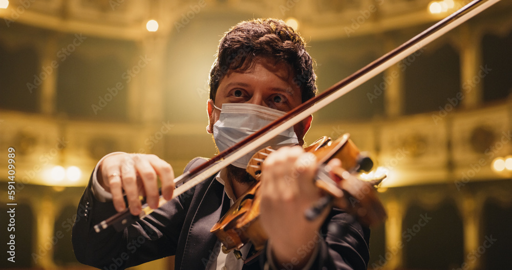 Cinematic Portrait of Male Violinist Playing Violin in an Orchestra