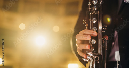 Cinematic Closeup of the Hands of a Male Saxophone Player Playing his Instrument. Professional Musician Rehearsing Before the Start of a Big Jazz Show on a Classical Theatre Stage