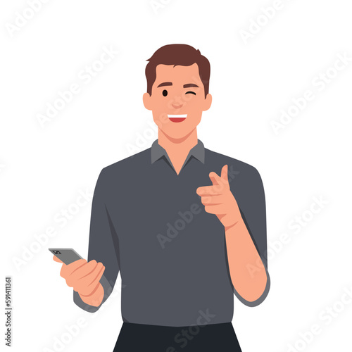 Confident man pointing finger at camera while holding phone to press button on invisible screen. Young man wink and points to display with hand calling to attend event or participate in promotion.