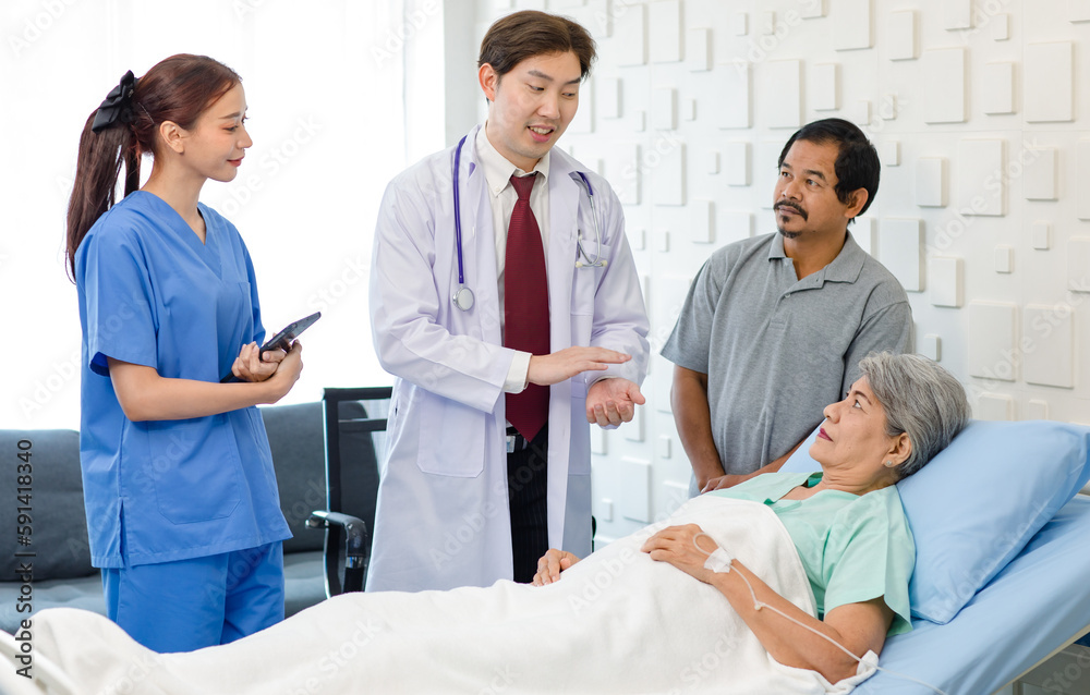 Asian professional successful male doctor in white lab coat with stethoscope female assistant internship nurse in blue uniform holding tablet computer visiting old senior unhealthy patient in ward Asian professional successful male doctor in white lab coat with stethoscope female assistant internship nurse in blue uniform holding tablet computer visiting old senior unhealthy patient in ward