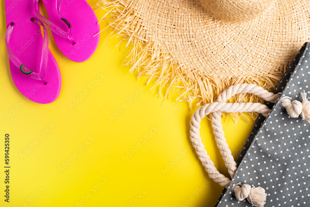 Flip flops straw hat and beach bag on yellow background vacation travel planning mockup Flip flops straw hat and beach bag on yellow background vacation travel planning mockup