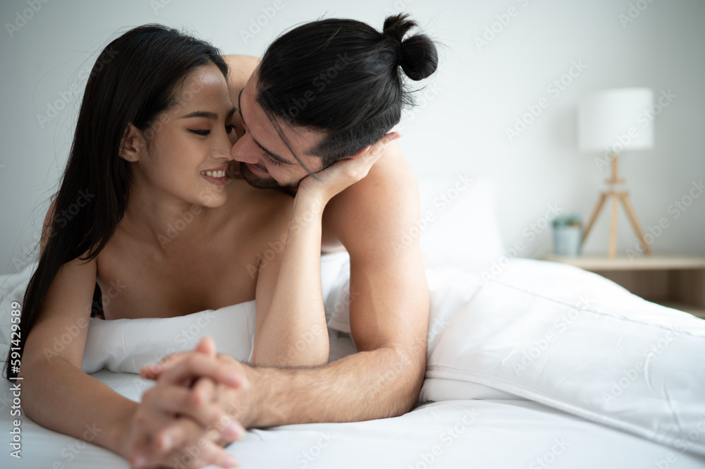 Gorgeous sexy couple enjoying arousing sex before having sex on bed in home bedroom The concept of emotional and love relationships. Gorgeous sexy couple enjoying arousing sex before having sex on bed in home bedroom The concept of emotional and love relationships.