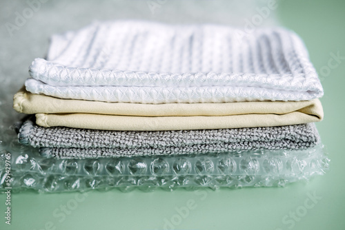 Recycling Fibers in the Textile Industry. Sustainable recycled cotton fiber. Many napkins fabrics made of recycled polyester synthetic fabric and bubble wrap photo