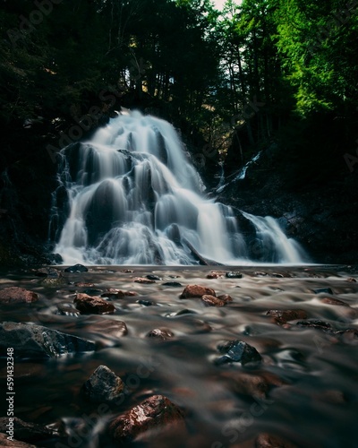 Long exposure of a waterfall flowing through stones in a park in Nova Scotia  Canada